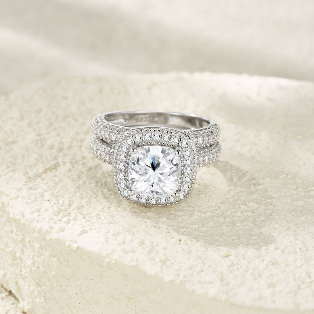Silver ring with a large diamond on a textured beige background