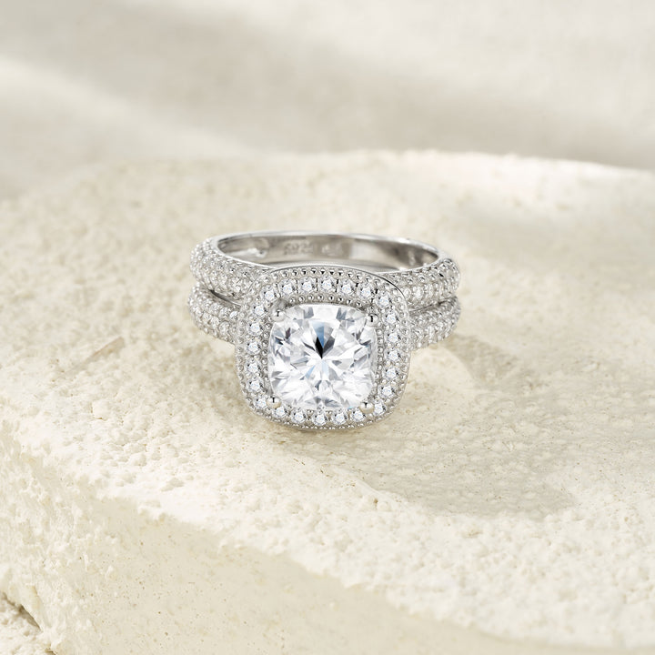 Silver ring with a large diamond on a textured beige background