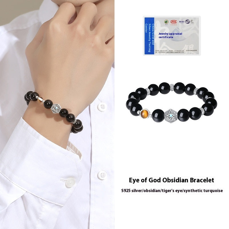 Black beaded bracelet with silver charm on wrist, jewelry appraisal certificate in the corner