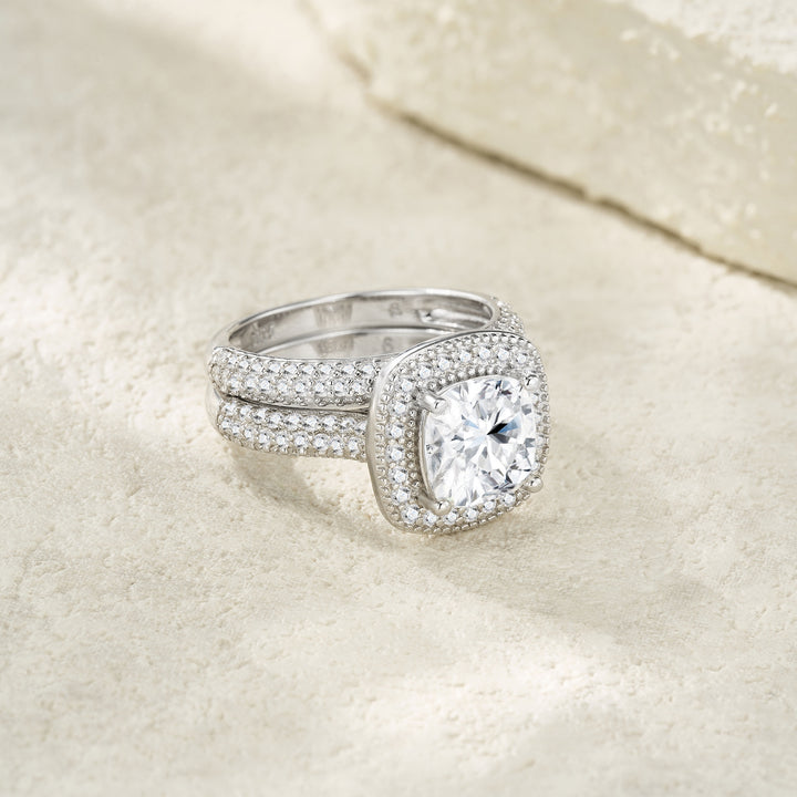 Silver ring with a large diamond on a beige fabric background