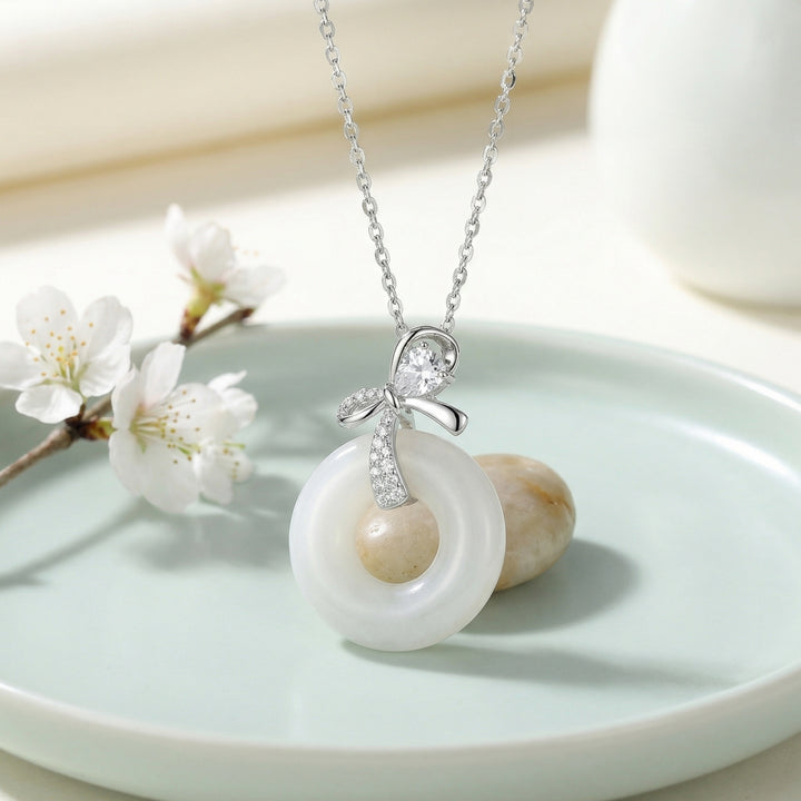 925 Sterling Silver Elegant White Jade Donut Pendant Necklace with Sparkling Silver Bow Accent