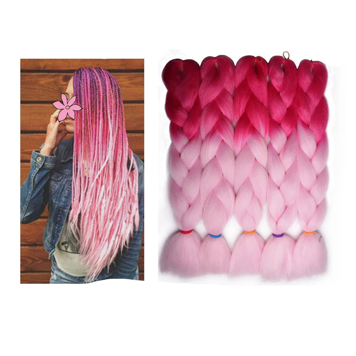 Pink and red ombre hair extensions with a person wearing them 