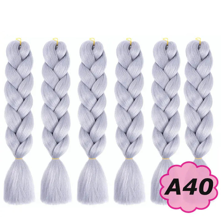 Set of six braided hair extensions with on a white background.