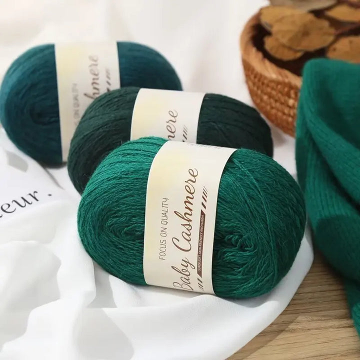 Green yarn skeins with labels on a white surface