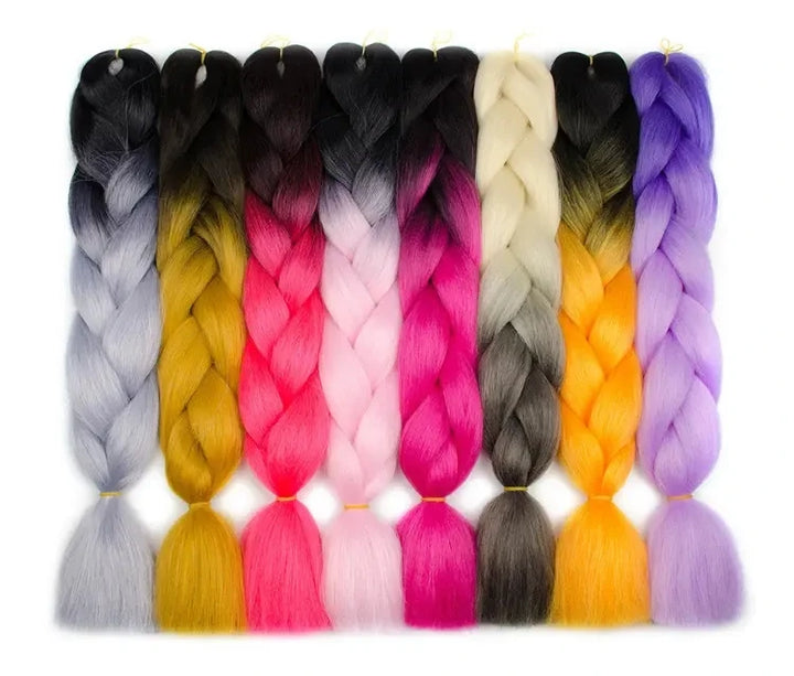 Assorted colored braided hair extensions on a white background