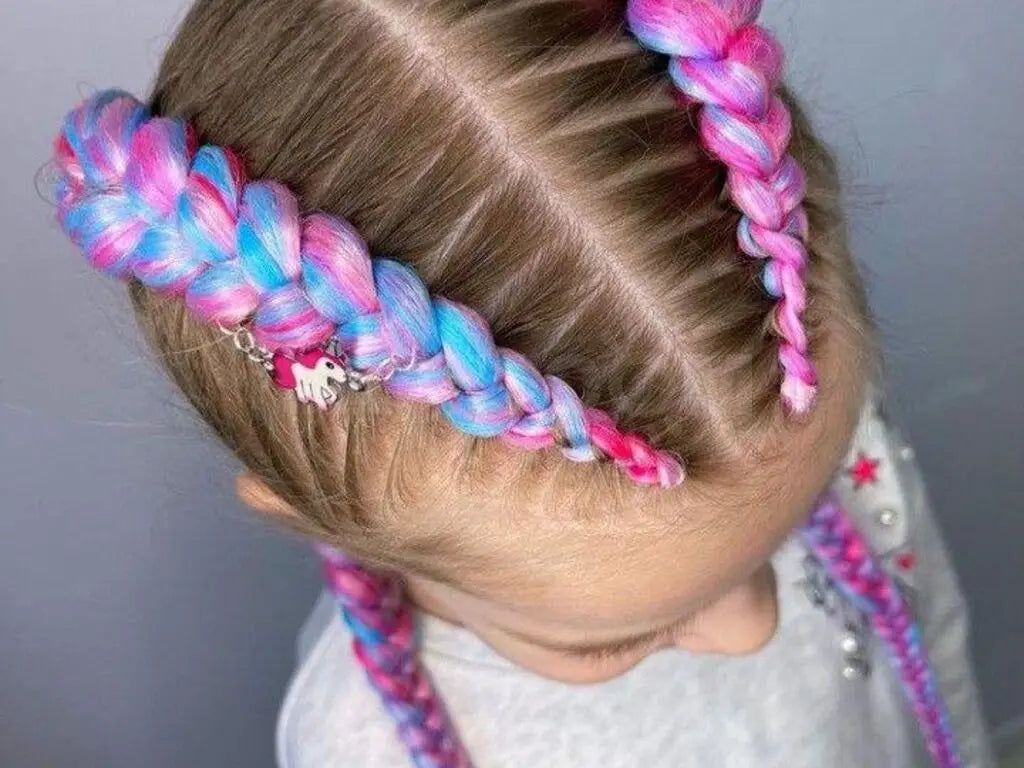 Child with colorful braided hair against a plain background