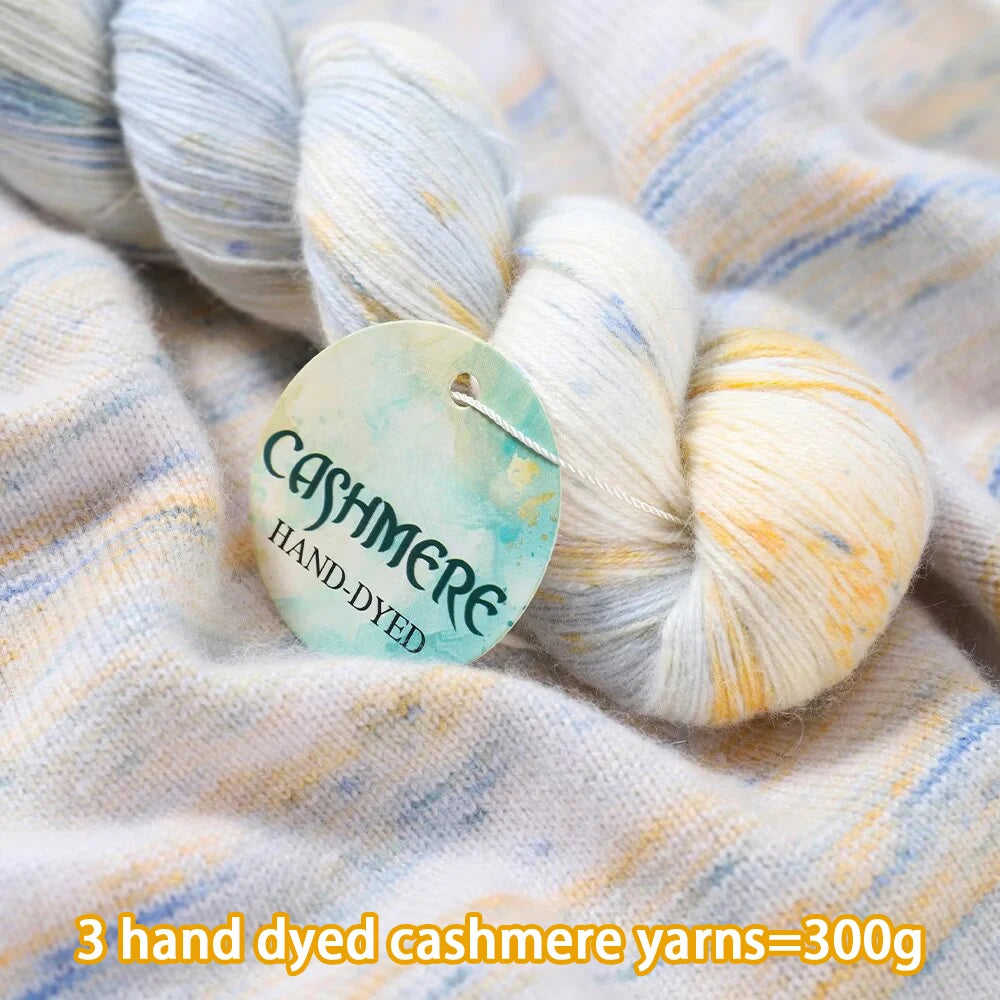 Hand-dyed cashmere yarn with a label on a textured fabric background