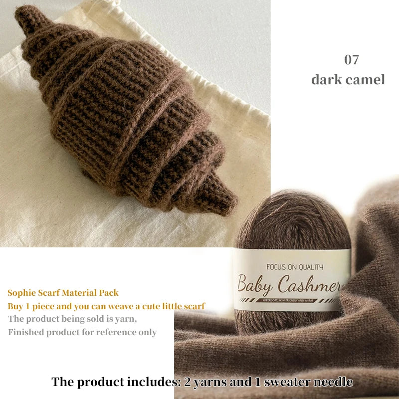 Brown knitted item and ball of yarn with 'Baby Cashmere' label on a white background