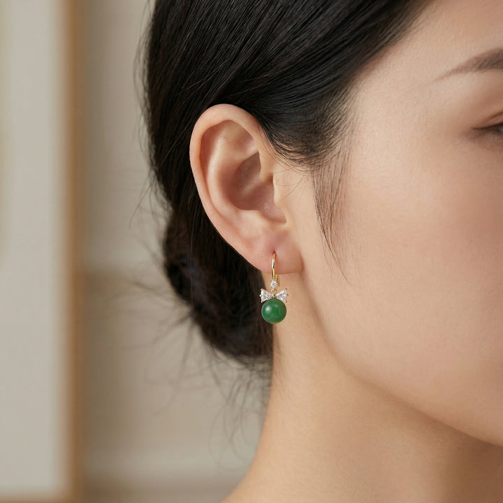 Close-up of a person wearing a green earring with a blurred background