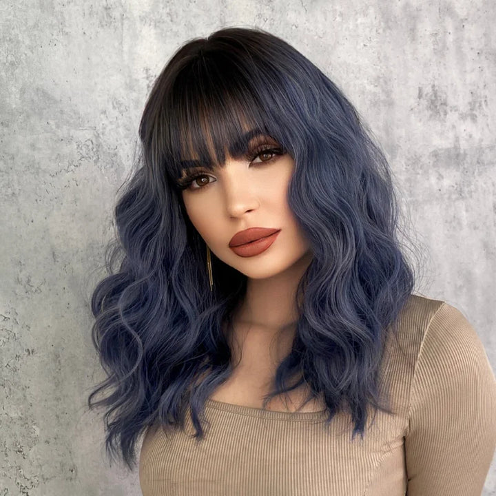 Short curly ombre blue wig with bangs for women. Shoulder-length wavy bob style made of synthetic hair. Perfect for daily wear, cosplay, and Halloween.