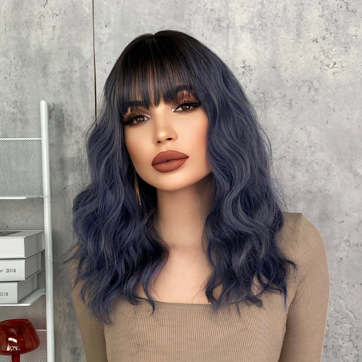 Short curly ombre blue wig with bangs for women. Shoulder-length wavy bob style made of synthetic hair. Perfect for daily wear, cosplay, and Halloween.