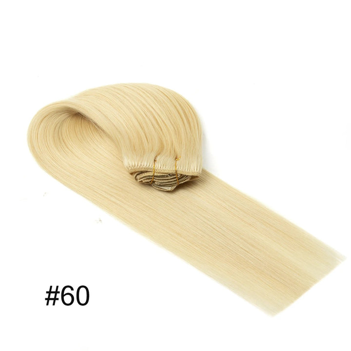 Blonde hair extension with a clip on a white background