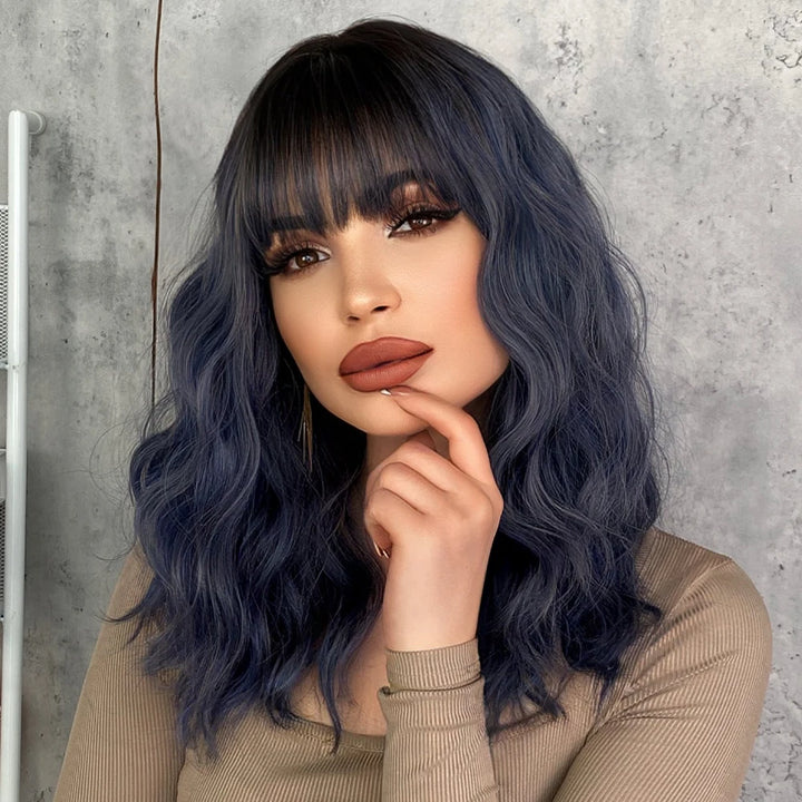 Short curly ombre blue wig with bangs for women. Shoulder-length wavy bob style made of synthetic hair. Perfect for daily wear, cosplay, and Halloween.