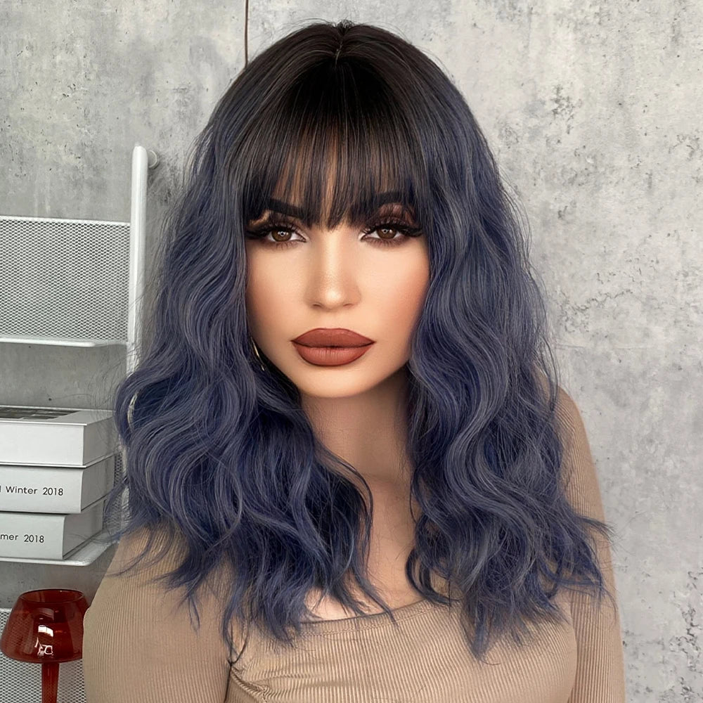 Short curly ombre blue wig with bangs for women. Shoulder-length wavy bob style made of synthetic hair. Perfect for daily wear, cosplay, and Halloween.