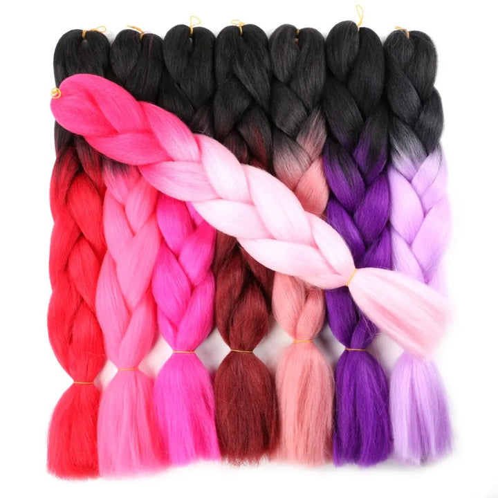 Set of colorful braided hair extensions on a white background