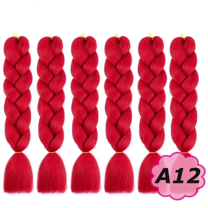 Red braided hair extensions with branding on a white background.