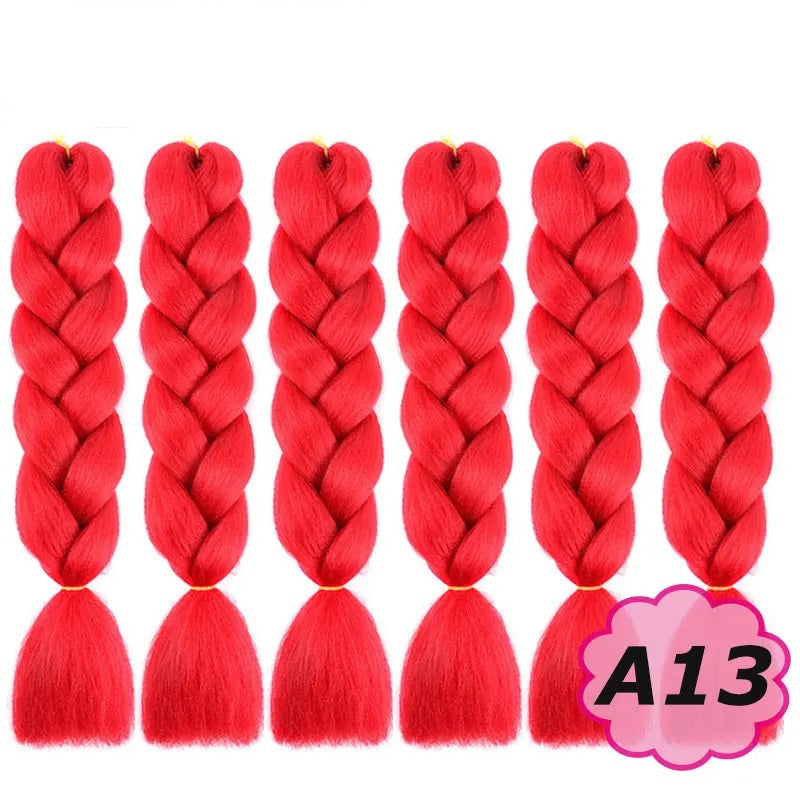 Red braided hair extensions with branding on a white background.