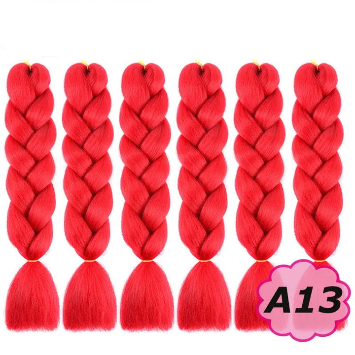 Red braided hair extensions with branding on a white background.