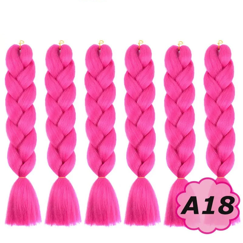 Pink braided hair extensions with  branding on a white background.