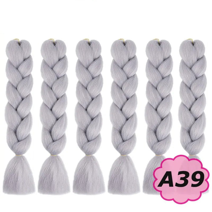 Gray braided hair extensions with branding on a white background.