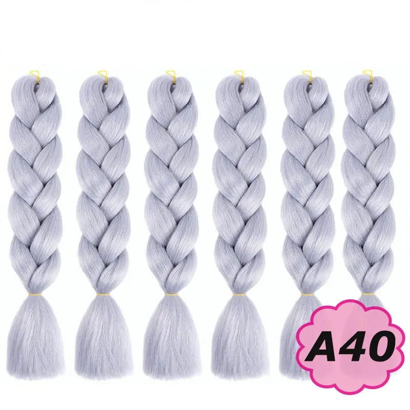 Set of six braided hair extensions with on a white background.