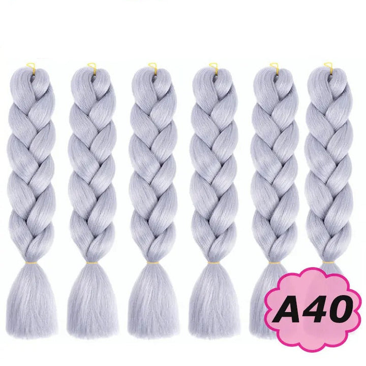 Set of six braided hair extensions with on a white background.