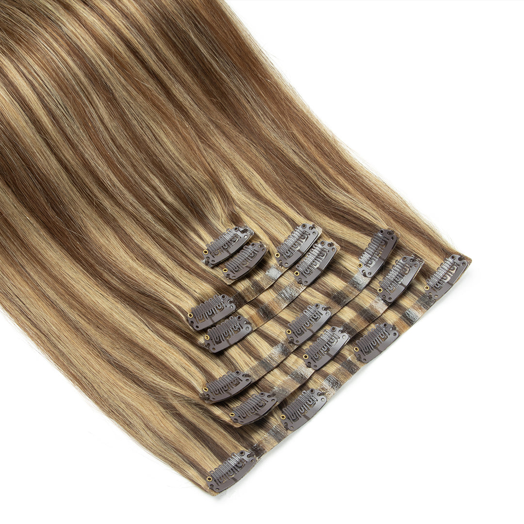 Set of hair extensions with clips on a white background